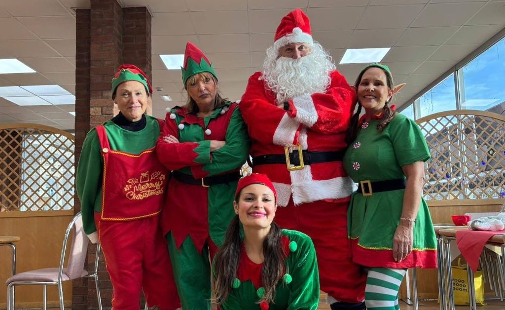 Group of people dressed up as Elves and Santa.