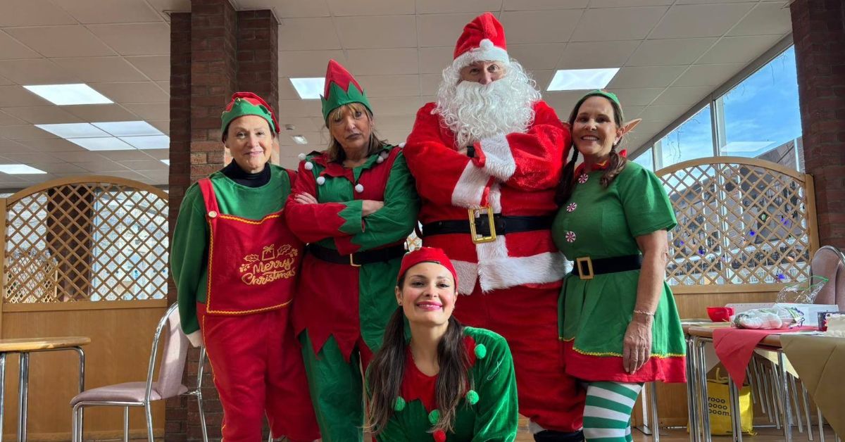 Group of people dressed up as Elves and Santa.